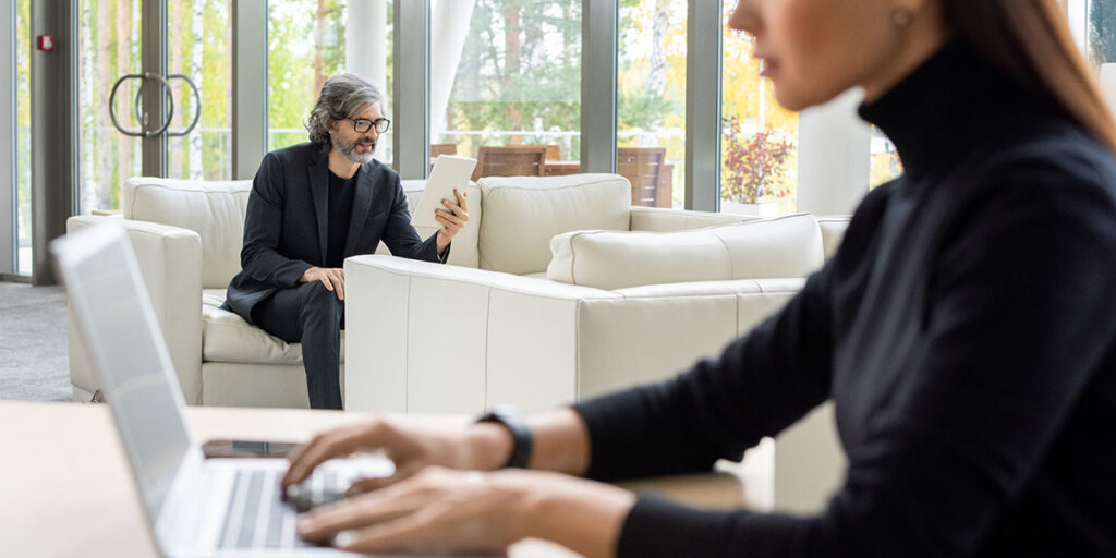Small business owner writing a brand voice guide with tone descriptors and language examples to use across marketing channels