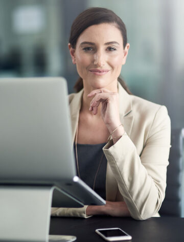 Ontario small business owner working through a marketing audit checklist on a laptop with a notepad and pen nearby