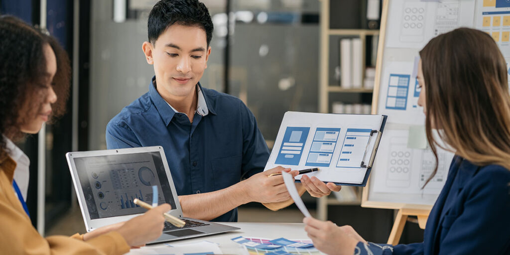 Ontario business owner reviewing the results of a recent marketing campaign against a predetermined goal and baseline in a notebook