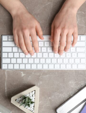 Small business owner writing a long-form blog post to use as anchor content for a multi-channel repurposing strategy