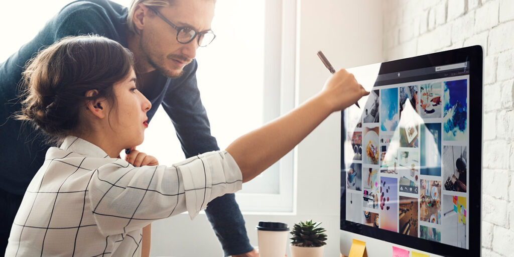 Business owner consulting with a web support specialist about structural website issues that go beyond a surface-level refresh