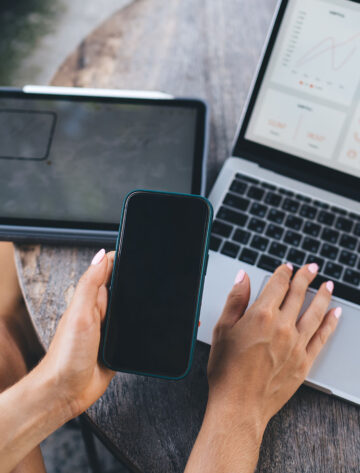 Ontario small business owner reviewing their existing website on a laptop and tablet to decide whether it needs a refresh or a full rebuild